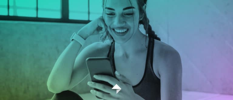 fit woman smiling at her phone