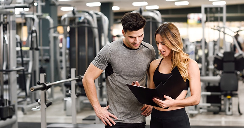 MAN AND WOMAN AT GYM