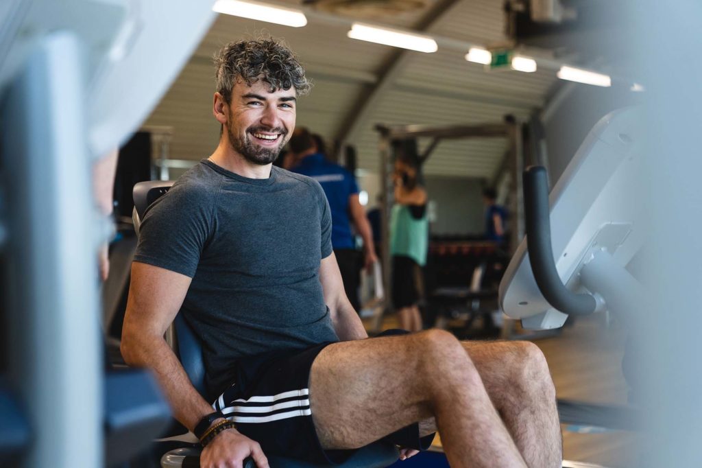 man smiling while working out