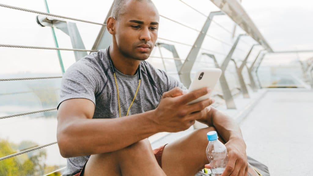 personal trainer scrolling on phone