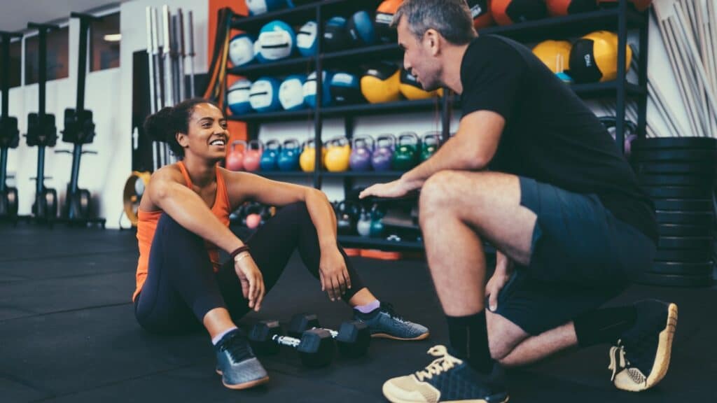 personal trainer working with client