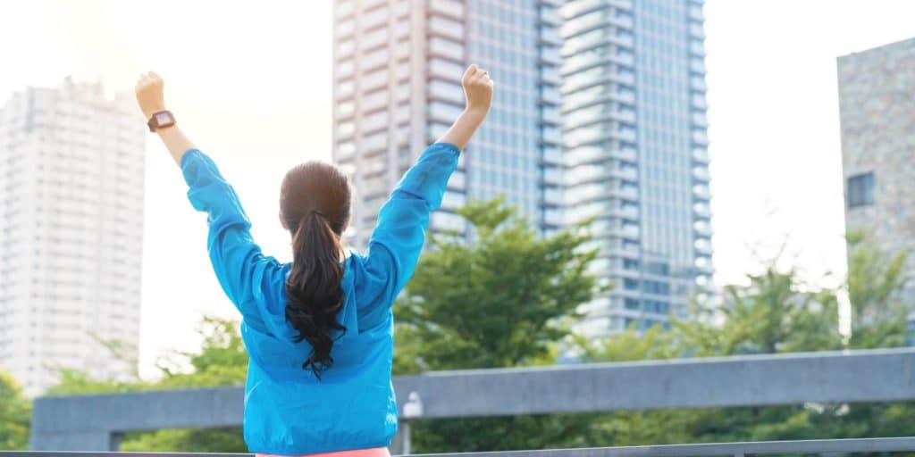 woman in workout clothes celebrating