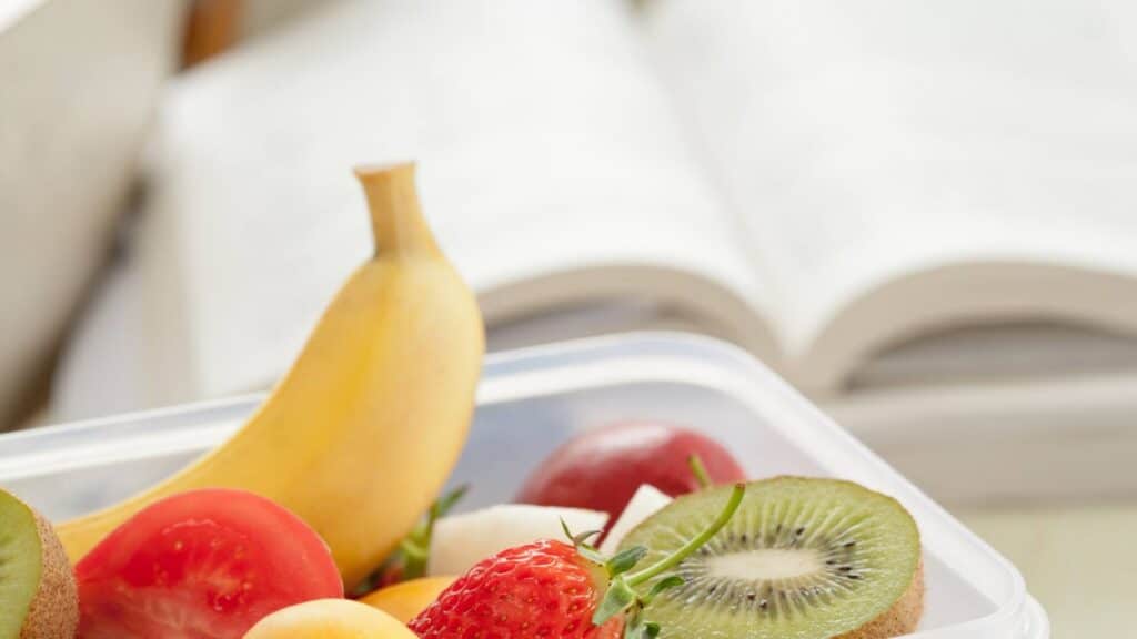 personal trainer books with fruit in front